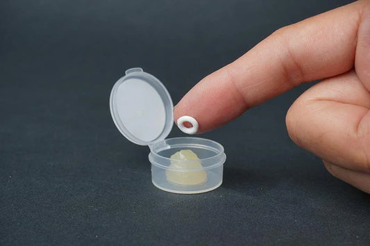 Koswork O-ring grease KOS02013 for RC cars, small clear case, finger holding white O-ring