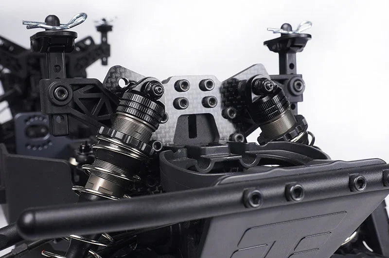 Close-up of RC car aluminum shock absorbers and carbon fiber shock tower