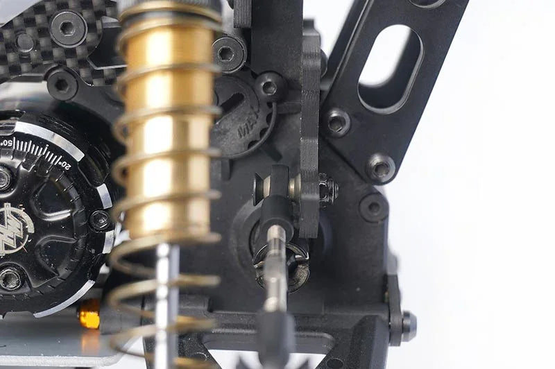 Koswork RC car shock absorber and suspension parts close-up, metal and carbon fiber components.