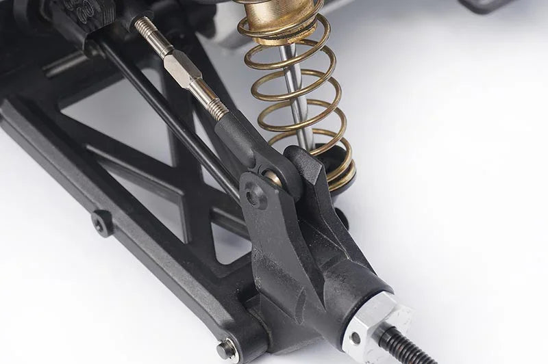 Koswork RC car suspension arm, black plastic with gold shock absorber, close-up view