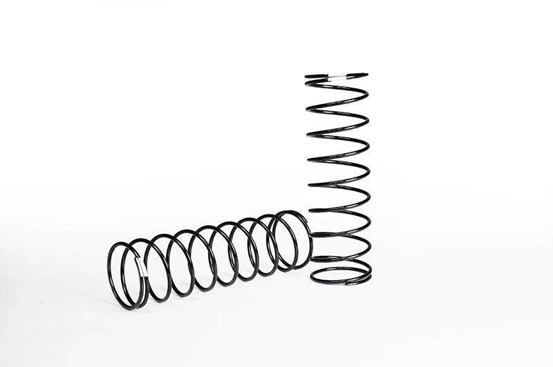 Two black RC car suspension springs on a white background, one upright, one lying down