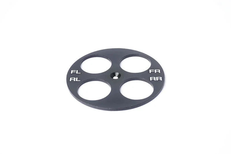 Black RC car setup wheel plate with FL, FR, RL, RR markings and four large holes