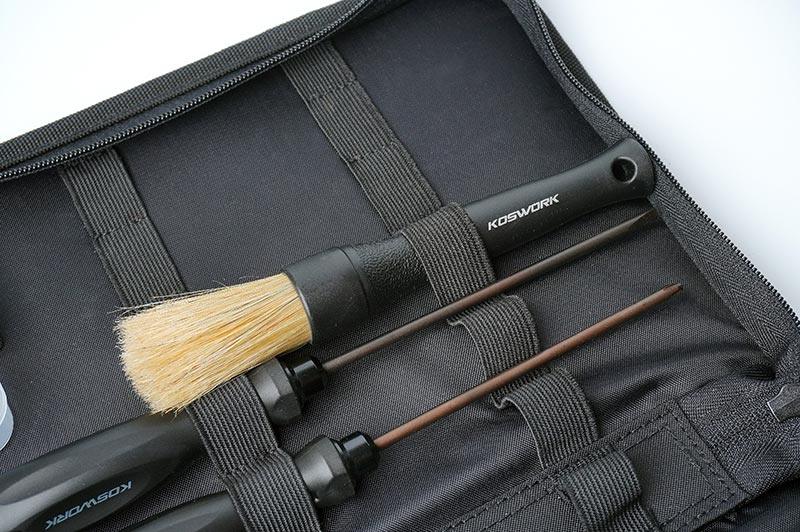Koswork RC tool kit with brush and hex drivers in black fabric organizer bag, close-up view.
