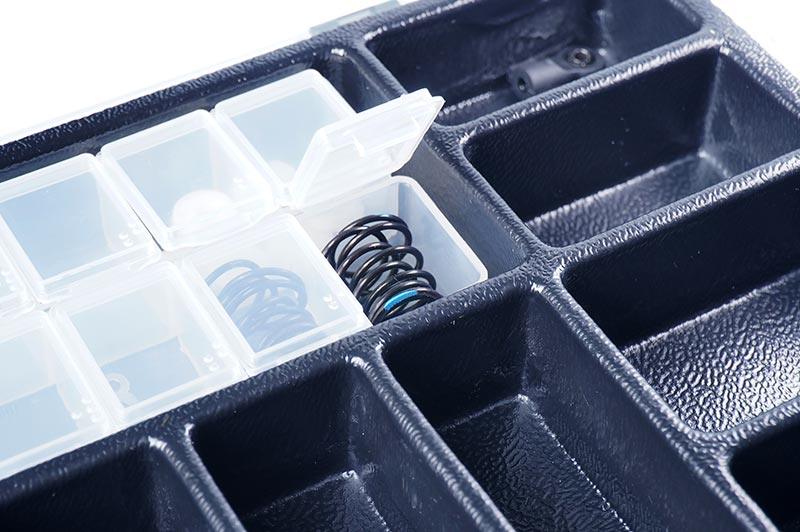 Close-up of a plastic hobby organizer box with small springs in clear compartments.