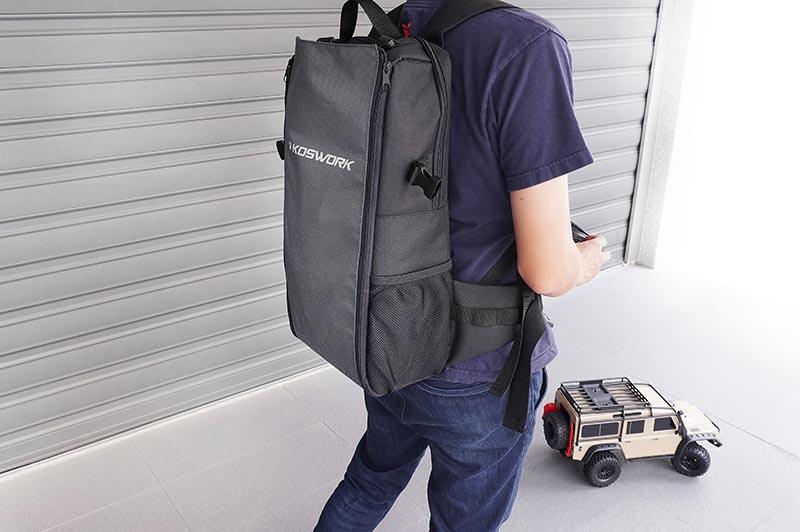 Koswork KOS32213BK-24 black RC car carrying backpack with mesh pockets, worn outdoors