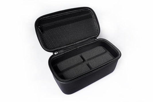 Black RC tool storage case with foam insert and mesh zipper pouch, open on white background