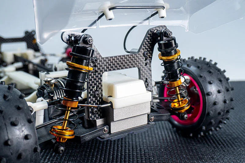 Close-up of RC car suspension, carbon fiber shock tower, and off-road tires