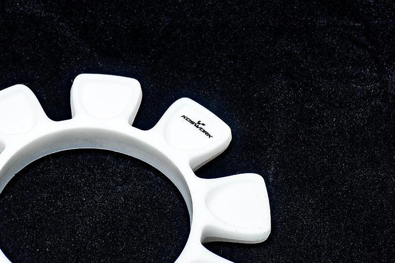 White Koswork RC tool holder with distinct slots on a black surface