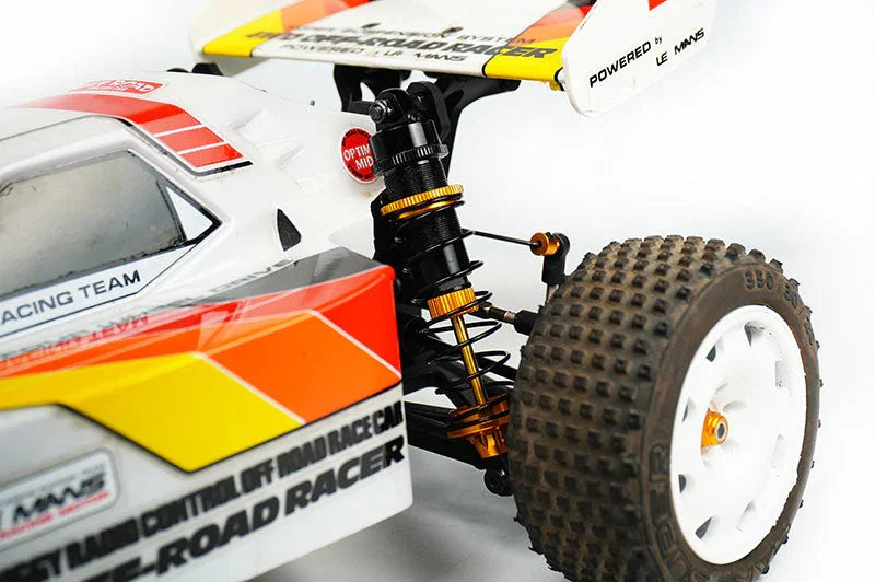 Close-up of RC off-road car with shock absorber, knobby tire, and racing decals