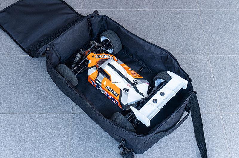 RC car transporter bag with orange and white remote control racing car inside, open on tile floor