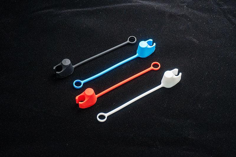 Koswork RC car silicone dust caps in black, blue, red, and white, long strap design.
