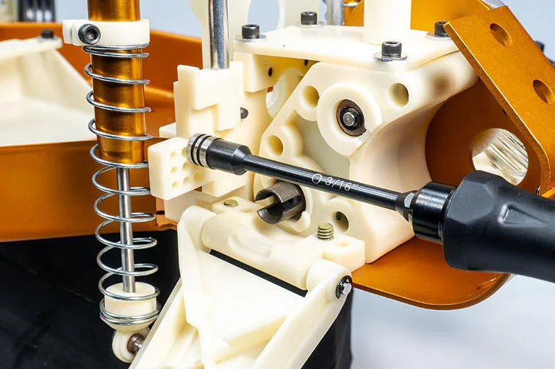 Koswork RC car tool set in use on white plastic suspension parts, hex driver visible