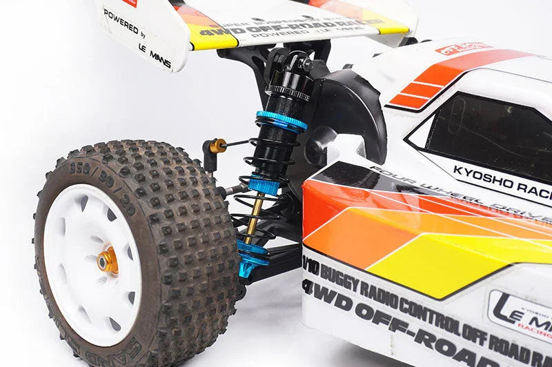 Close-up of RC off-road buggy front wheel, suspension, and colorful body decals