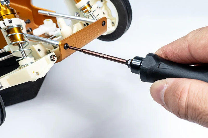 Koswork RC car accessory, precision hex driver tool in use on gold aluminum suspension arm