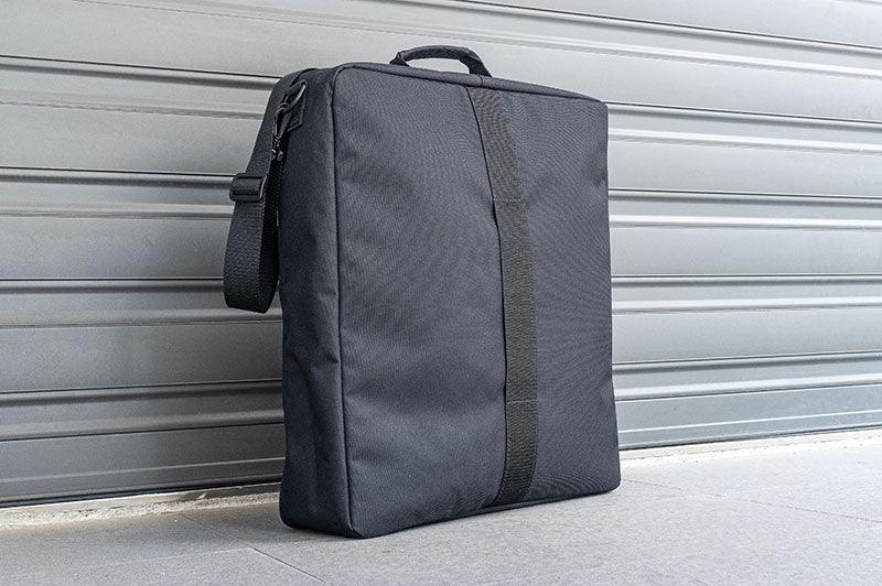Black RC tools and accessories pit bag with handle and shoulder strap on pavement
