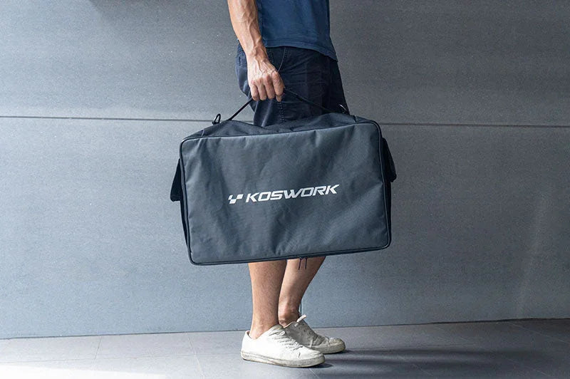 Man carrying a large Koswork RC pit bag, ideal for remote control car tools and accessories.
