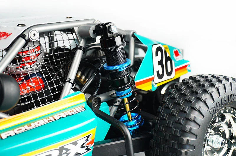 Close-up of RC car shock absorber, off-road tire, and roll cage detail
