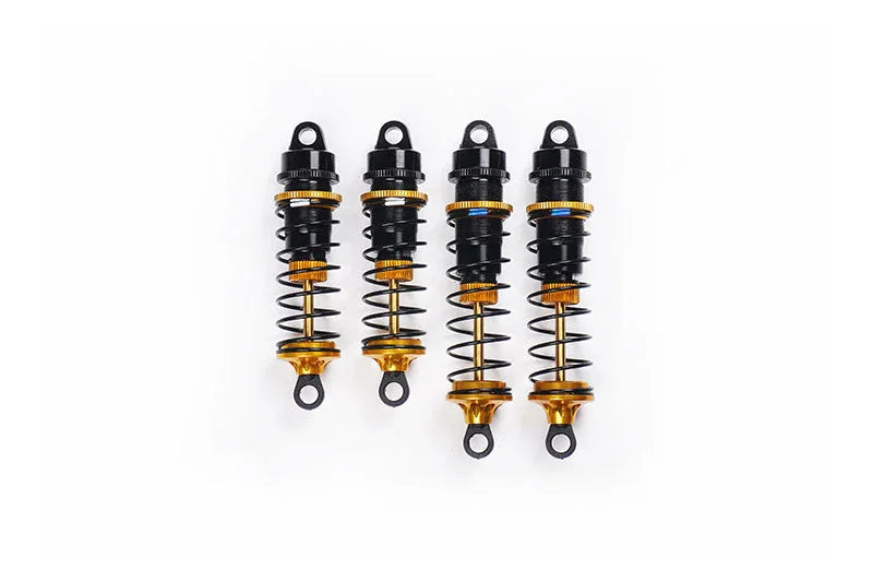 Set of four gold and black RC car shock absorbers with springs on white background