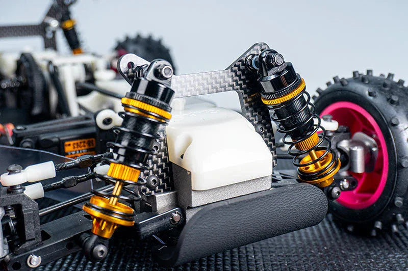 Close-up of an RC car suspension system with shock absorbers and off-road tire