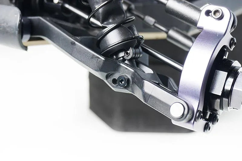 Close-up of RC car suspension arm and shock absorber, showcasing RC parts and accessories.