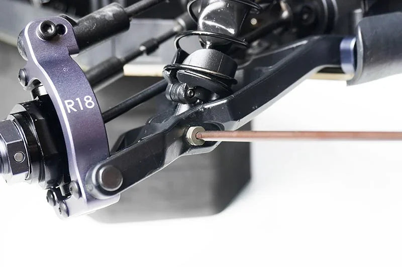 Close-up of RC car suspension and steering assembly with R18 marking, showing detailed parts.