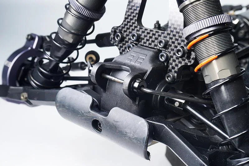 Close-up of RC car suspension and shock absorbers with carbon fiber components