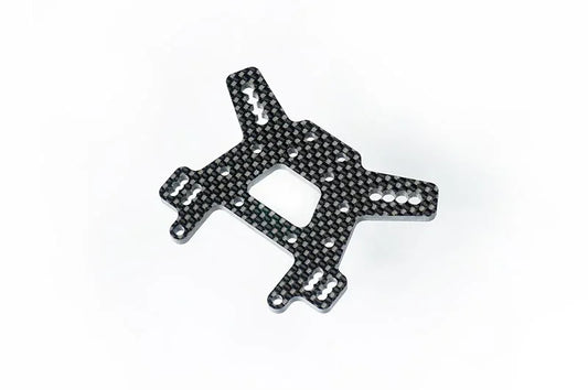 Carbon fiber RC car chassis plate with precision cutouts on white background