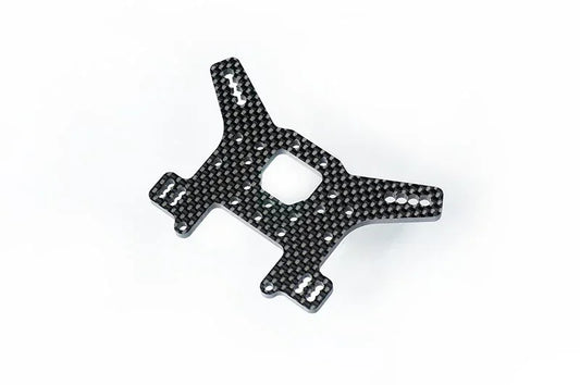 Carbon fiber RC car part with cutouts, displayed on a white background.