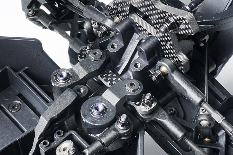 Close-up of RC car front suspension and carbon fiber shock tower assembly