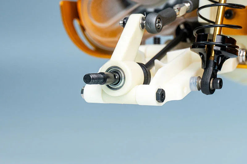 Close-up of RC car suspension arm and shock absorber, showing detailed assembly.