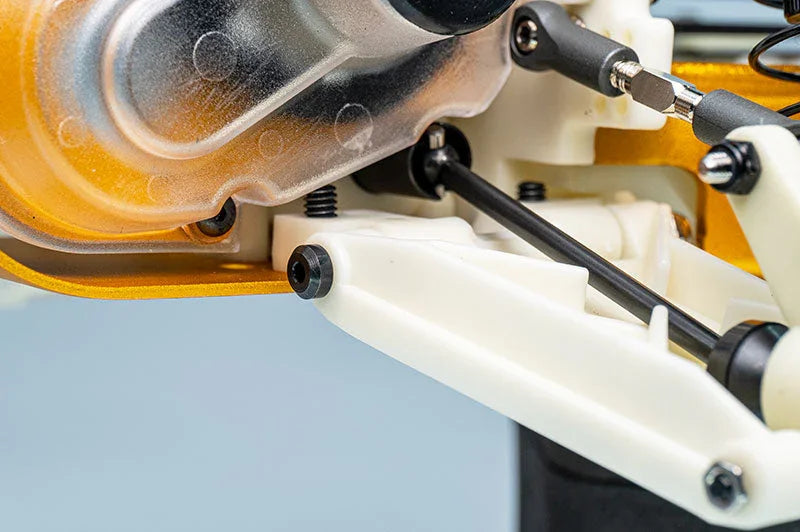 Close-up of RC car suspension arm, linkage, and metal gear housing