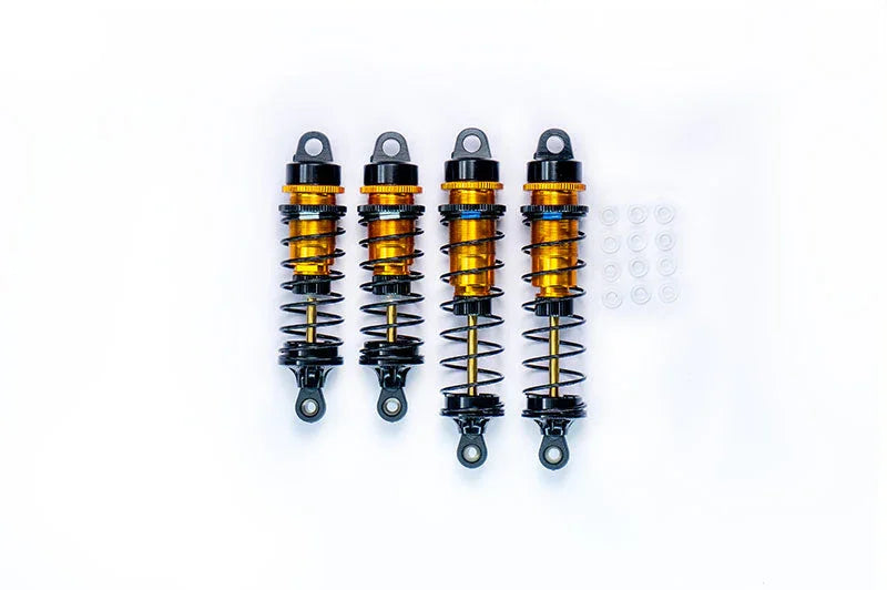 Set of four RC car shock absorbers with orange springs and mounting accessories on white background