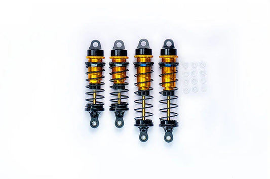 Set of four RC car shock absorbers with orange springs and mounting accessories on white background