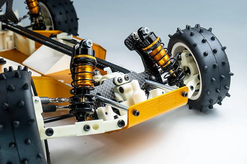 Close-up of RC car suspension system with shock absorbers and spiked tires