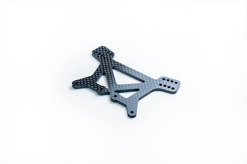 Carbon fiber RC car chassis plate with multiple mounting holes on a white background