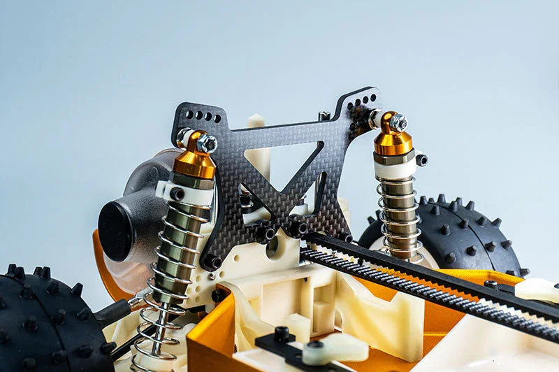 Close-up of a carbon fiber RC car shock tower with shock absorbers and detailed chassis.