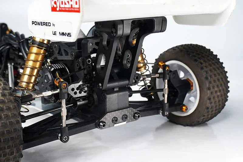 Close-up of RC car rear suspension, shock absorbers, and off-road tire components