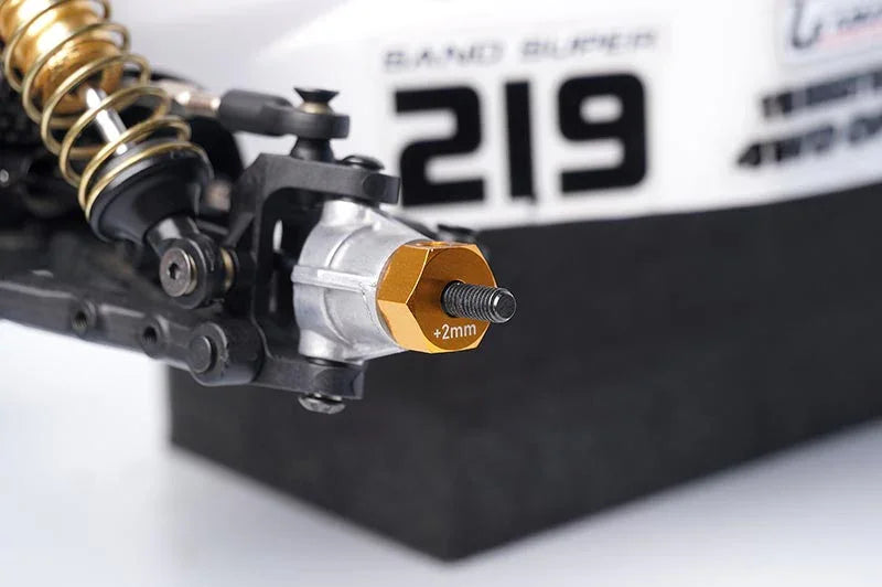 Koswork RC car aluminum 2mm wheel hex hub, gold color, close-up on suspension part.