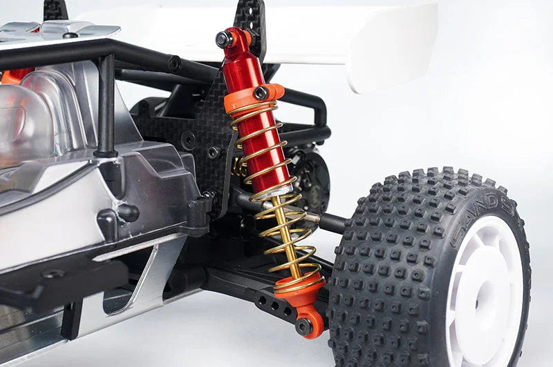 Close-up of RC car suspension, metal shock absorber, off-road knobby tire, white rim