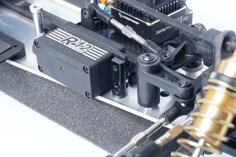 Koswork RC car servo R12, black metal component, mounted on aluminum chassis