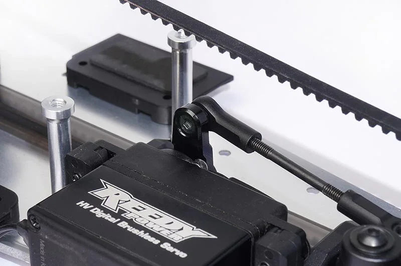 Koswork RC car accessory, close-up of metal servo mount and linkage, detailed assembly
