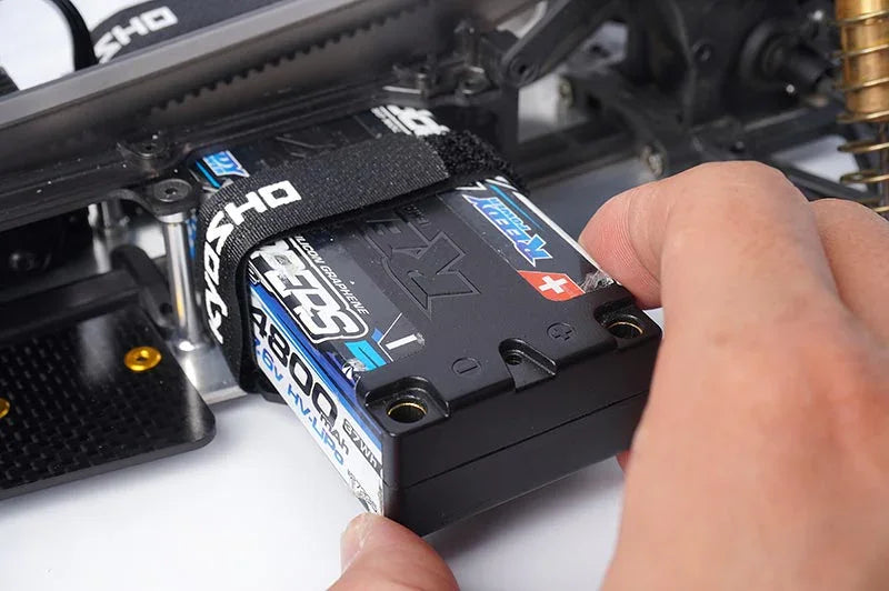 Koswork RC car battery strap securing black hard case LiPo battery pack with hand adjustment