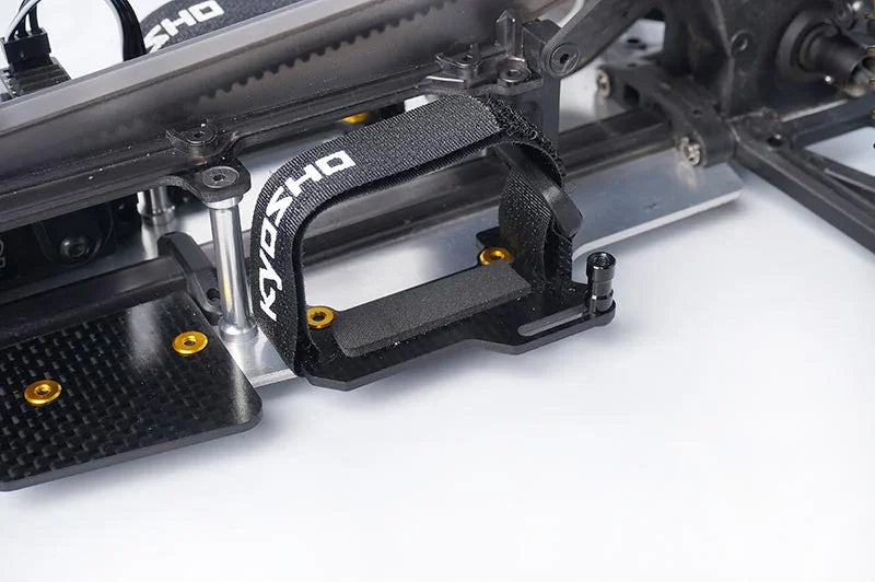 Koswork RC car black battery holder with Velcro strap and gold screws, chassis accessory