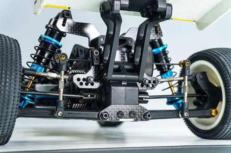 Koswork RC car suspension system with blue aluminum shocks and reinforced chassis close-up
