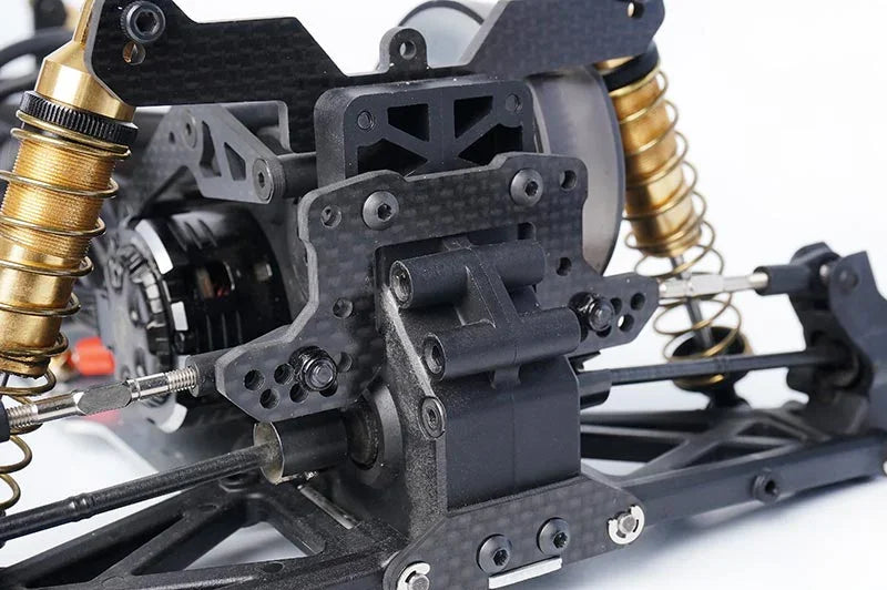 Koswork RC car carbon fiber shock tower, black chassis, and gold aluminum shocks detail
