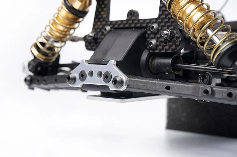 Koswork RC car precision aluminum suspension mount with gold shocks, black chassis detail