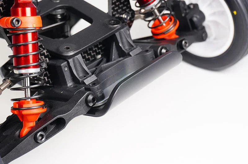 Close-up of RC car front suspension with red aluminum shocks and black bumper