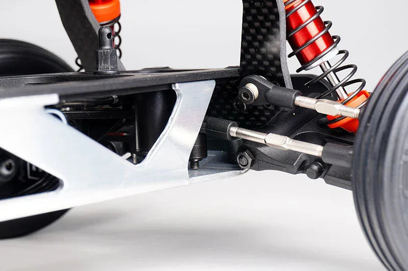 Close-up of RC car aluminum suspension arm, shock absorber, and steering linkage
