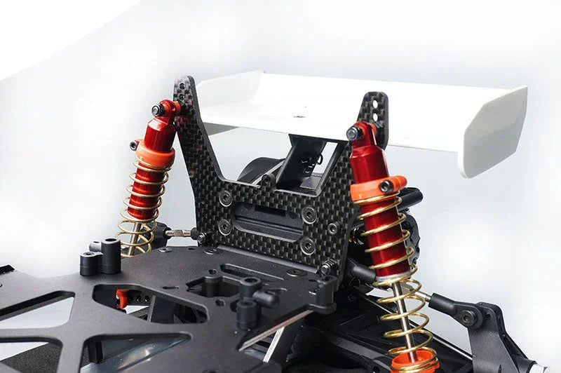 RC car rear chassis with carbon fiber shock tower, aluminum shocks, and wing