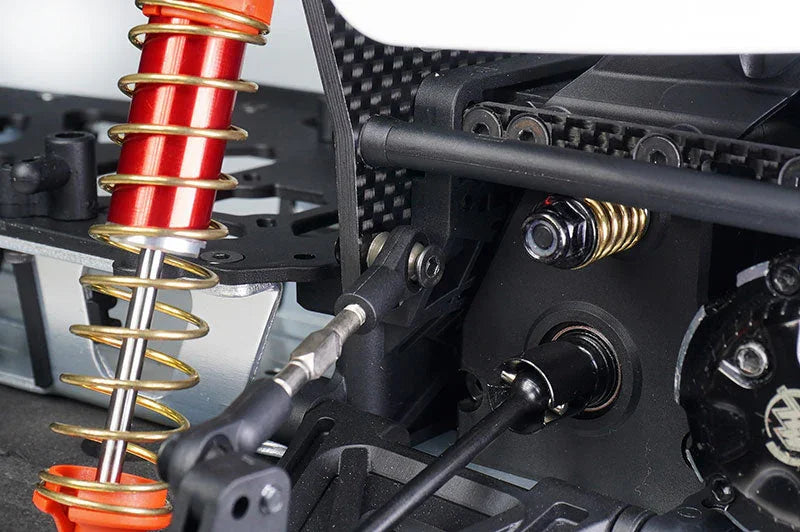 Close-up of RC car suspension, shock absorber, and drivetrain components